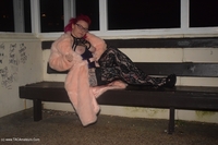 Red Inked Molly is outside in a pink fir coat with only purple lingerie and a red bra on underneath and of course no pan