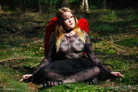 Rachel Rose, outdoors in see through bodystocking and red angel wings.