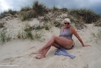 Dressed in a sheer silver dress on a local beach Check out how it clings to my body to show of my tits and nipples and t