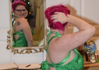 MollyFoxxx is in a Green Posh shiny dress, warming her bare arse and shaved pussy in front of an open fire, and of curse