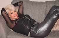 Dimonty wearing her black leather trouser and black top. Underneath she is wearing blue lingerie and stockings. Of cours